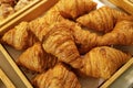 Pile of freshly baked croissant pastries for sale in the bakery