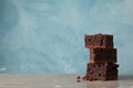 Pile of delicious chocolate cake slices on grey table Royalty Free Stock Photo