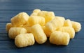 Pile of delicious crispy corn sticks on blue wooden table, closeup