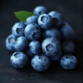 a pile of delicious fresh blueberries on a black stone table