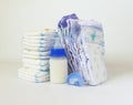 Pile of diapers and baby bottles on white background. Royalty Free Stock Photo