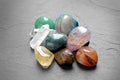 Pile of different beautiful gemstones on grey