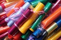 pile of different-coloured plastic gift wrap rolls in a box