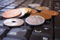 A pile of different Japanese coins lies on a black keyboard of a computer or laptop. Denomination is 1, 10, 50 yen. Online trading Royalty Free Stock Photo