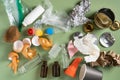 Pile of different of non sorted garbage of plastic, metal, organic, paper, glass on green studio background. Recycling Royalty Free Stock Photo