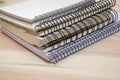 Pile of different notebooks lying on wooden table Royalty Free Stock Photo