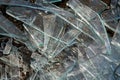 A pile of different sharp pieces of broken glass lying on the ground Royalty Free Stock Photo
