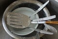 A pile of dirty dishes from bowls, plates and metal forks with spoons in water Royalty Free Stock Photo