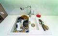 Pile of dirty dishes in white sink. View from above. Royalty Free Stock Photo