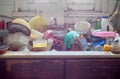 Pile of dirty utensils in a kitchen washbasin Royalty Free Stock Photo