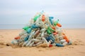 pile of discarded plastic bottles on a sandy beach