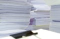 Pile of documents on desk stack up high waiting to be managed Royalty Free Stock Photo