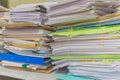 Pile of documents on desk stack up high waiting to be managed Royalty Free Stock Photo