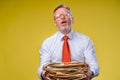 Pile of documents in hands. Senior man holding piles of documents paper work. Surprised of hard mental work Royalty Free Stock Photo