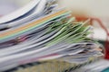 Pile of documents and notebook in red basket