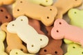 Pile of dog biscuits in the shape of a bone for pet on a white great for a pet.