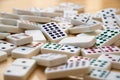 Pile of Dominoes on Wooden Floor Close Up Royalty Free Stock Photo