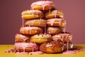 a pile of donuts with pink frosting on top