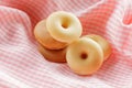 Pile of doughnut with pink cloth background.