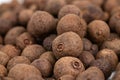 Pile of dried allspice fruits spices macro shot