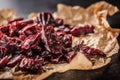 A pile of dried beef jerky pieces on paper and cutting board Royalty Free Stock Photo