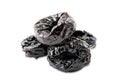 Pile of dried pitted prunes on white background