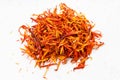 Pile of dried safflower petals close up on gray