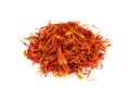 Pile of dried safflower petals closeup on white