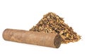 Pile of dried tobacco leaves and brown cigar isolated on white background