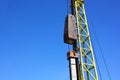 pile driving crane working in construction site against blue sky Royalty Free Stock Photo