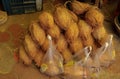 Pile of dry coconuts for sale outside a Hindu temple