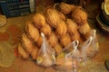 Pile of dry coconuts for sale outside a Hindu temple