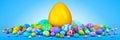 Pile of Easter eggs surrounding a giant golden egg