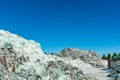 Pile of ecycle pieces of broken glass under blue sky