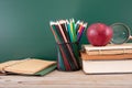 A pile of education-related items in front of the blackboard Royalty Free Stock Photo