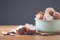 Pile of eggshells sits on a table against a gray background, symbolizing the potential benefits of eggshells in sustainability, Royalty Free Stock Photo