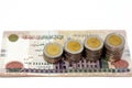 Pile of 200 EGP LE two hundred Egyptian pounds money banknotes with stacks of 1 LE EGP one pound coins isolated on white Royalty Free Stock Photo