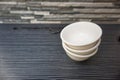 Pile of empty ceramic bowls on wooden table Royalty Free Stock Photo