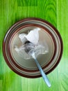 pile of empty plates and bowls with spoons covered in plastic and used food towels Royalty Free Stock Photo