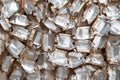 Pile of empty silver-gold candy wrappers. Top view. Royalty Free Stock Photo