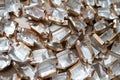 Pile of empty silver-gold candy wrappers. Top view. Royalty Free Stock Photo