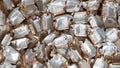 Pile of empty silver-gold candy wrappers. Top view. Royalty Free Stock Photo