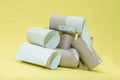 A pile of empty toilet paper tubes on a yellowbackground