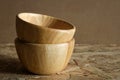 Pile empty wooden bowl on rustic wood background.