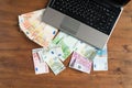 Pile of euro money with Laptop