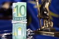 Pile of 100 euros surrounded by handcuffs on a flag of EU. Royalty Free Stock Photo