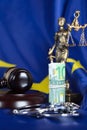 Pile of 100 euros surrounded by handcuffs on a flag of EU. Royalty Free Stock Photo