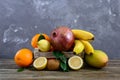 A pile of exotic fruits bananas, oranges, kiwi, pomegranate, mango, guava, lemon in a wooden box Royalty Free Stock Photo