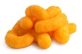 Pile of extruded cheese puffs isolated on white Royalty Free Stock Photo