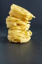 Pile of fettuccine in vertical on black background